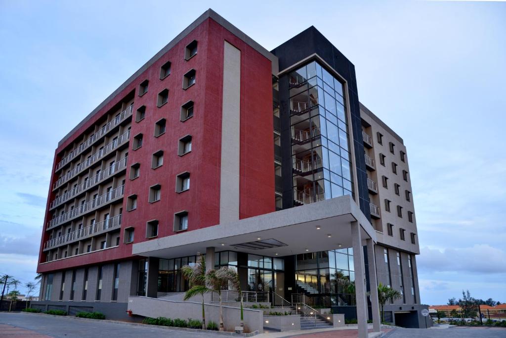 a red building with a white stripe on it at City Lodge Hotel Maputo, Mozambique in Maputo