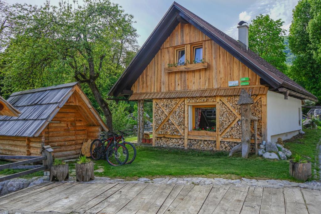 a log cabin with bikes parked outside of it at Hike & Bike Chalet in Bohinj