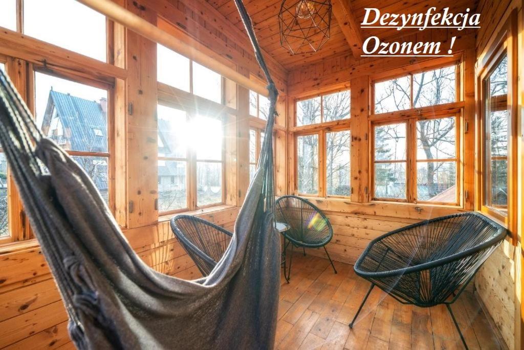 a room with two hammocks in a log cabin at Gabi Apartament Zakopane in Zakopane