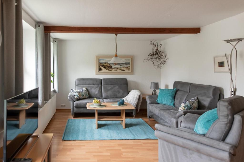 a living room with two couches and a table at Amrum in Kappeln