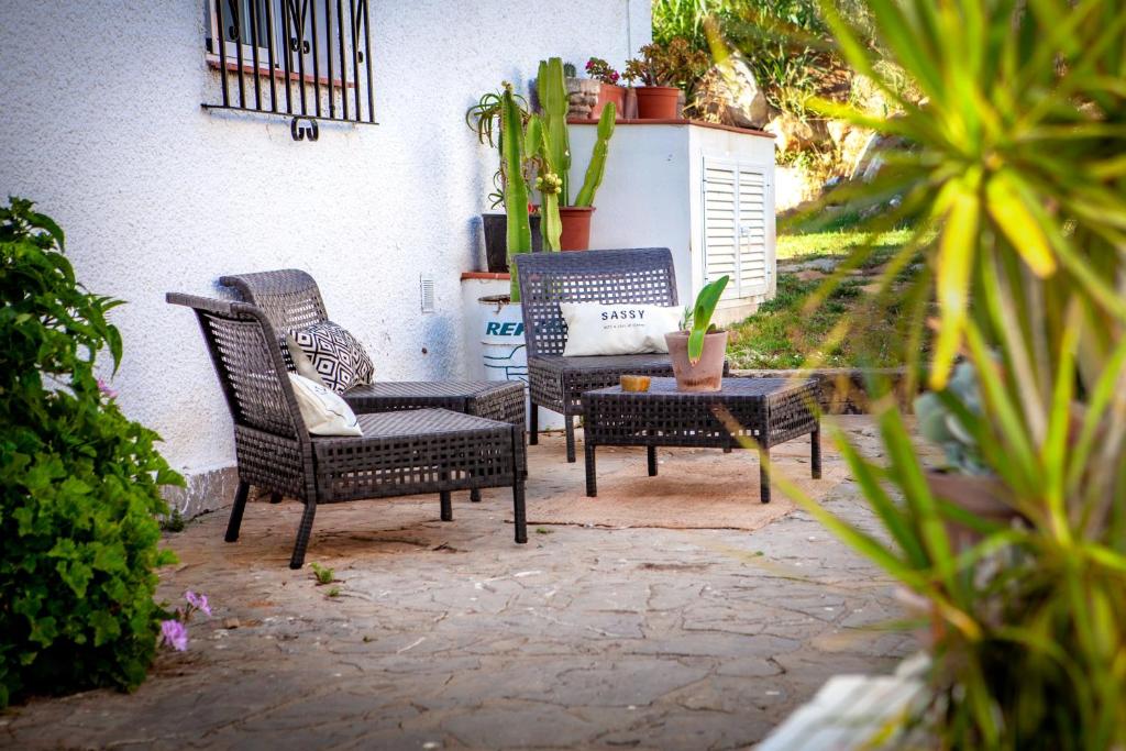 a patio with two chairs and a table with a couch at Wild House Tarifa in Tarifa