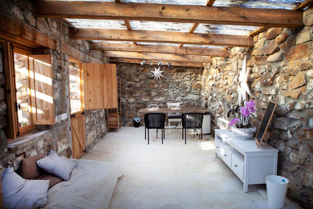 a living room with a table and a stone wall at Wild House Tarifa in Tarifa