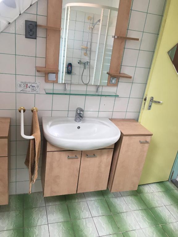 a bathroom with a sink and a mirror at Fanni Guest House in Balatonvilágos
