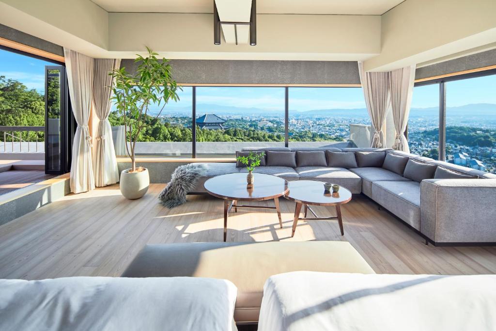 a living room with a couch and a table at ANDO HOTEL NARA Wakakusayama -DLIGHT LIFE & HOTELS- in Nara