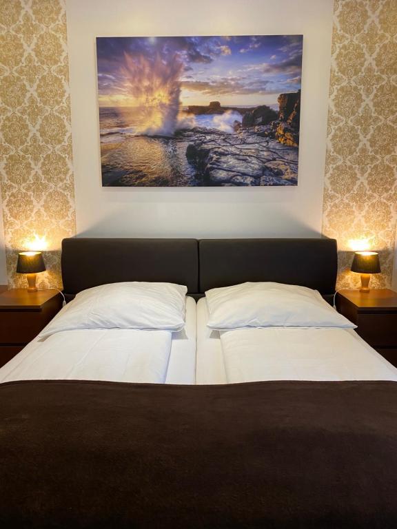 a hotel room with a bed and a painting on the wall at PREMIUM Hostel in Berlin