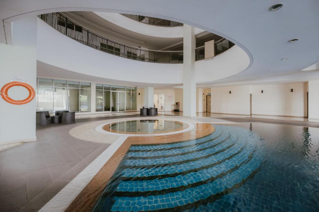 a swimming pool in a building with a large ceiling at 231TR by the Betty Roux Heritage in Kuala Lumpur