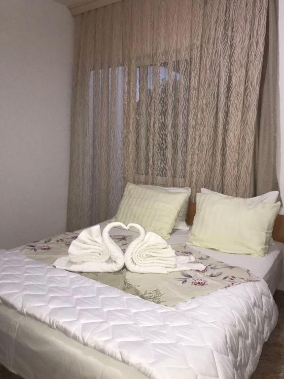 Postel nebo postele na pokoji v ubytování Robi Apartments
