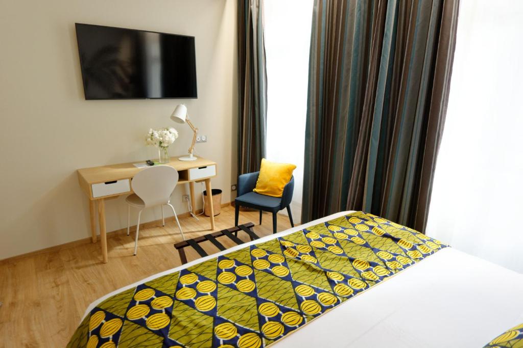 Postel nebo postele na pokoji v ubytování Hôtel Moderna