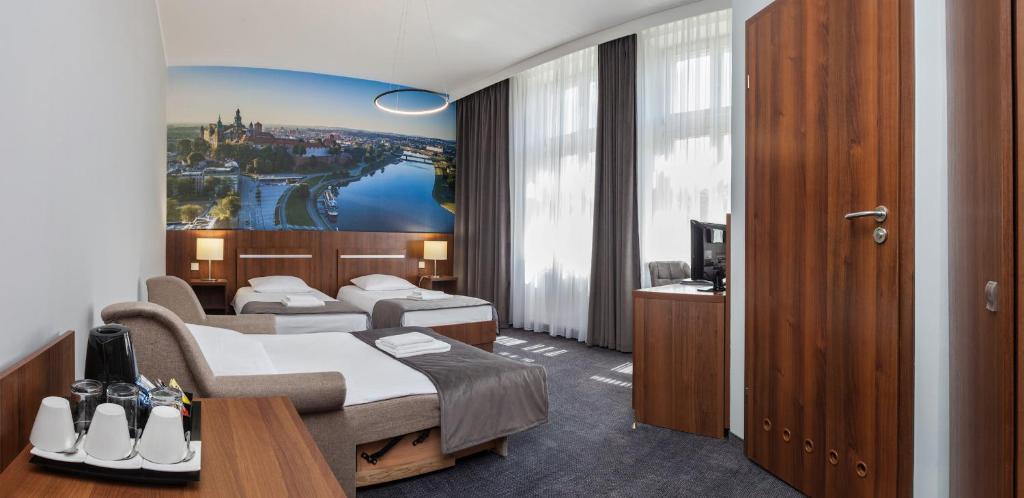 Łóżko lub łóżka w pokoju w obiekcie Hotel Downtown Kraków