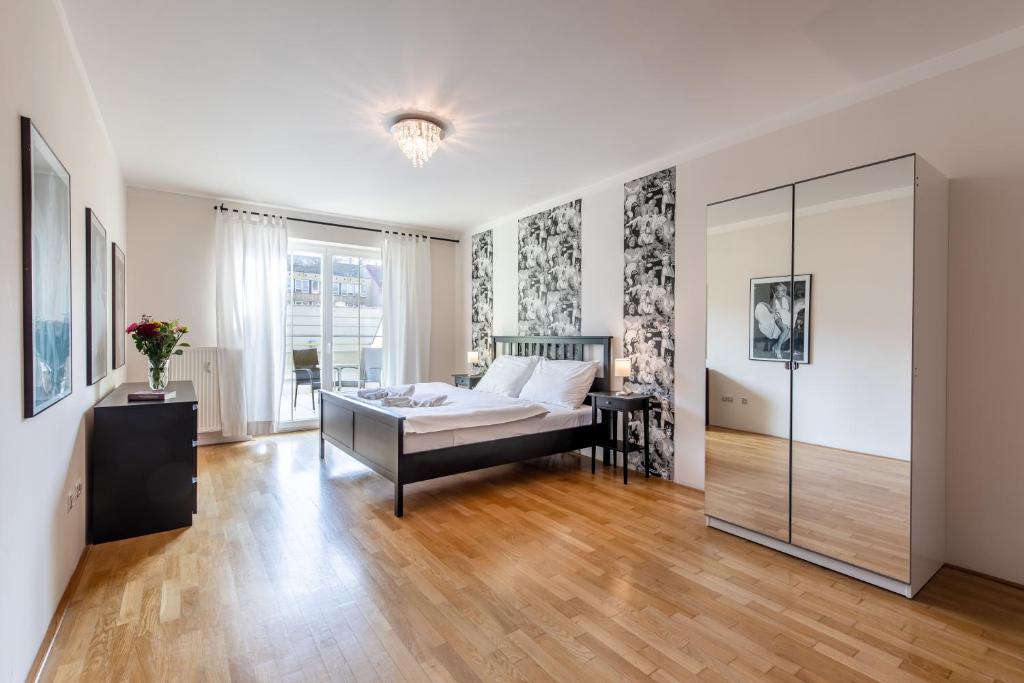 1 dormitorio con 1 cama y pared de cristal en Rezidence Čertovka, en Karlovy Vary
