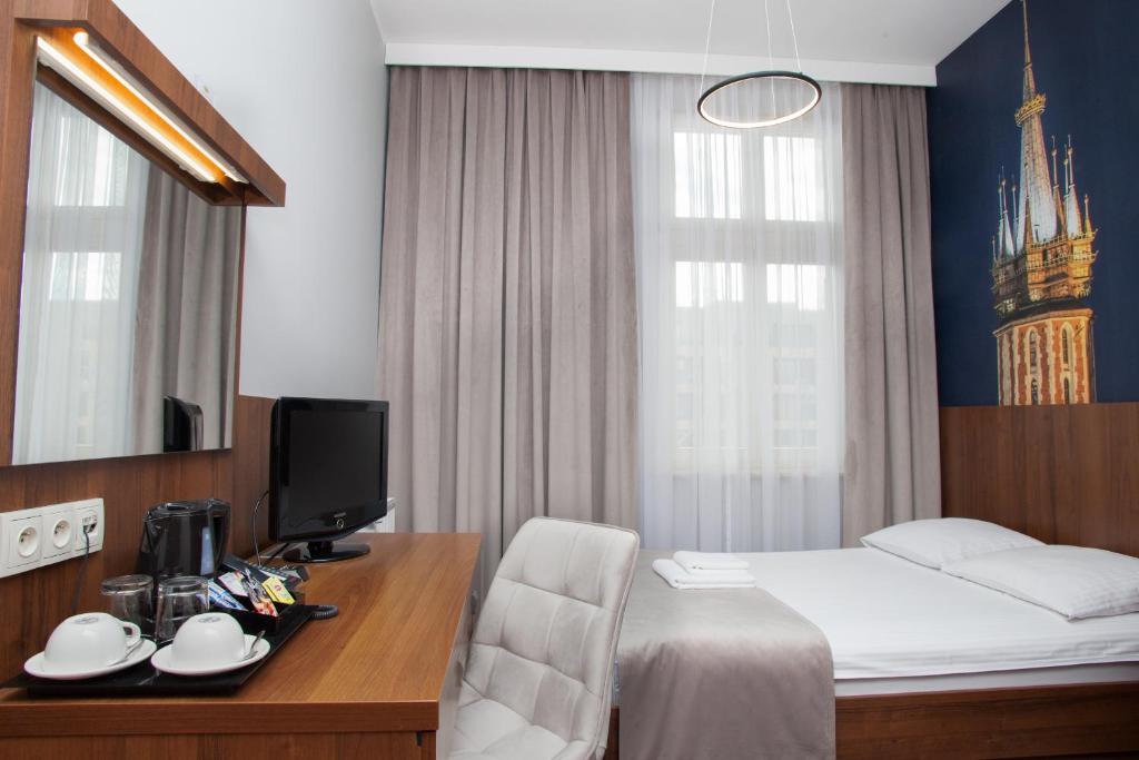 Łóżko lub łóżka w pokoju w obiekcie Hotel Downtown Kraków