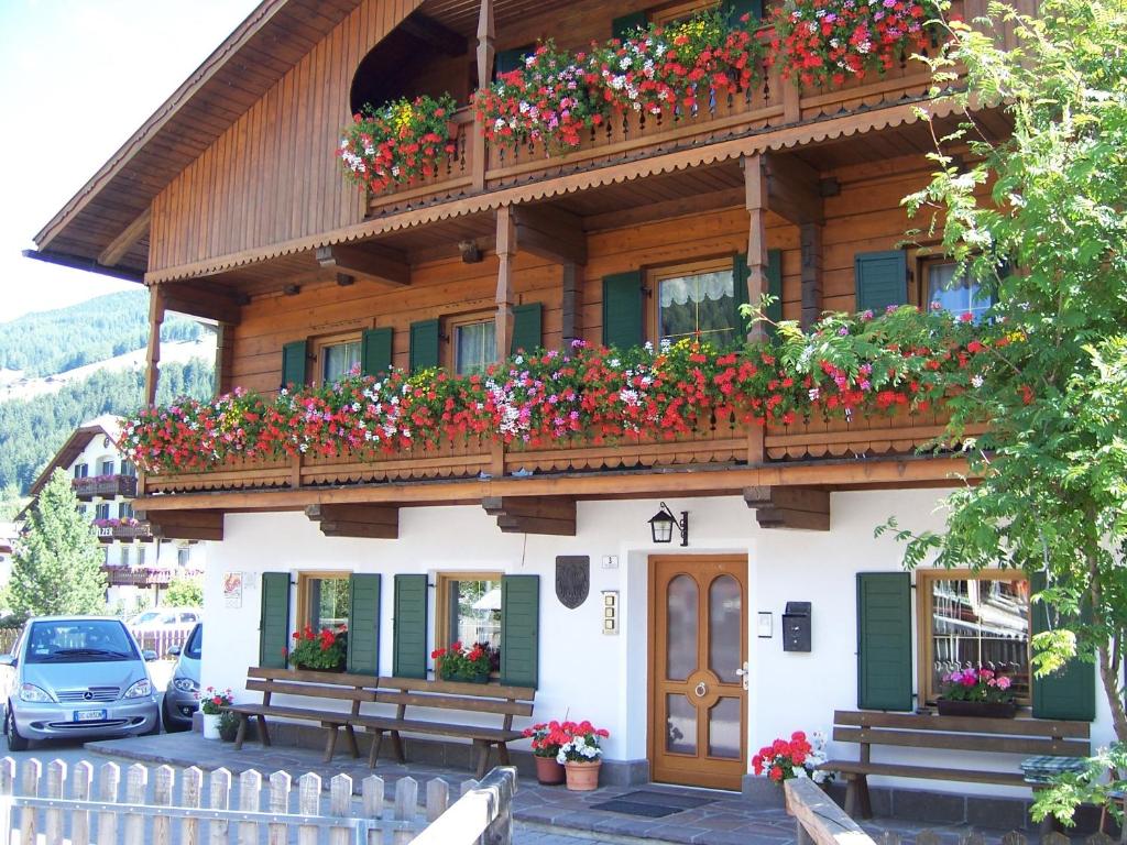 a building with flower boxes on the side of it at Obersanterhof in Sesto
