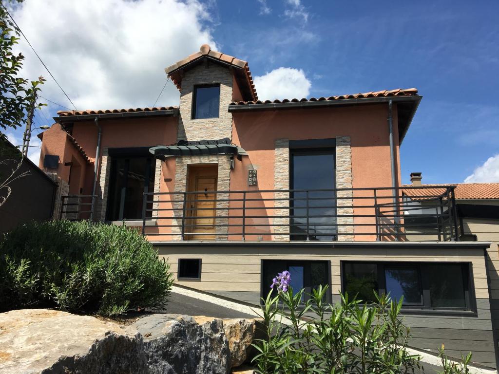 a large house with a balcony on top of it at La Mésange in Millau