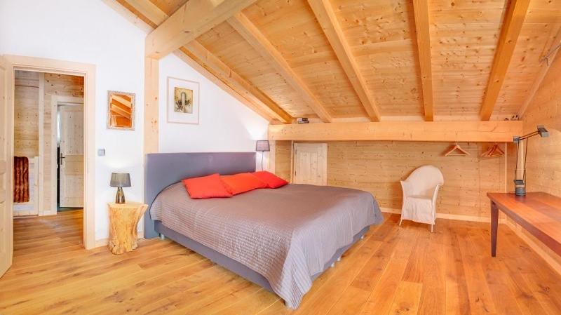 a bedroom with a bed and a wooden ceiling at Les 4 Chamois - Chalet - BO Immobilier in Abondance