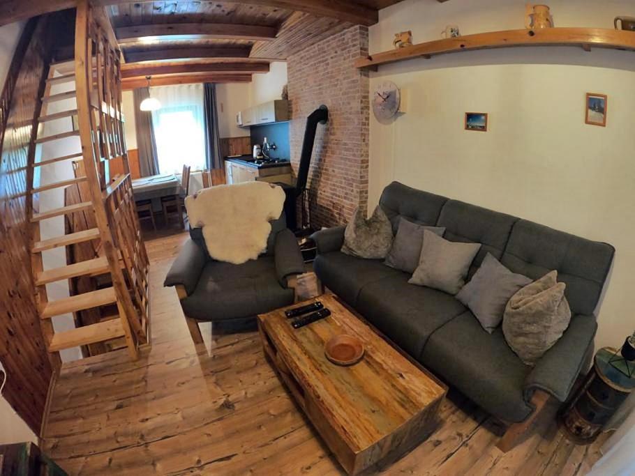 a living room with a couch and a coffee table at Apartmán U Sjezdovky in Železná Ruda