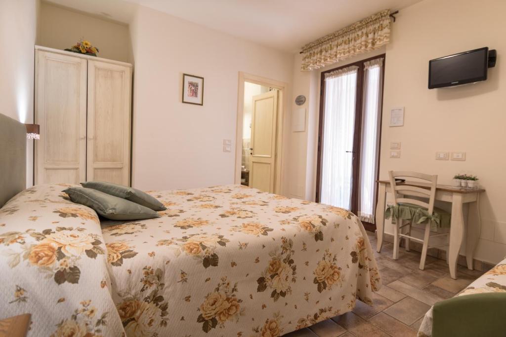Postel nebo postele na pokoji v ubytování Rosa di Assisi