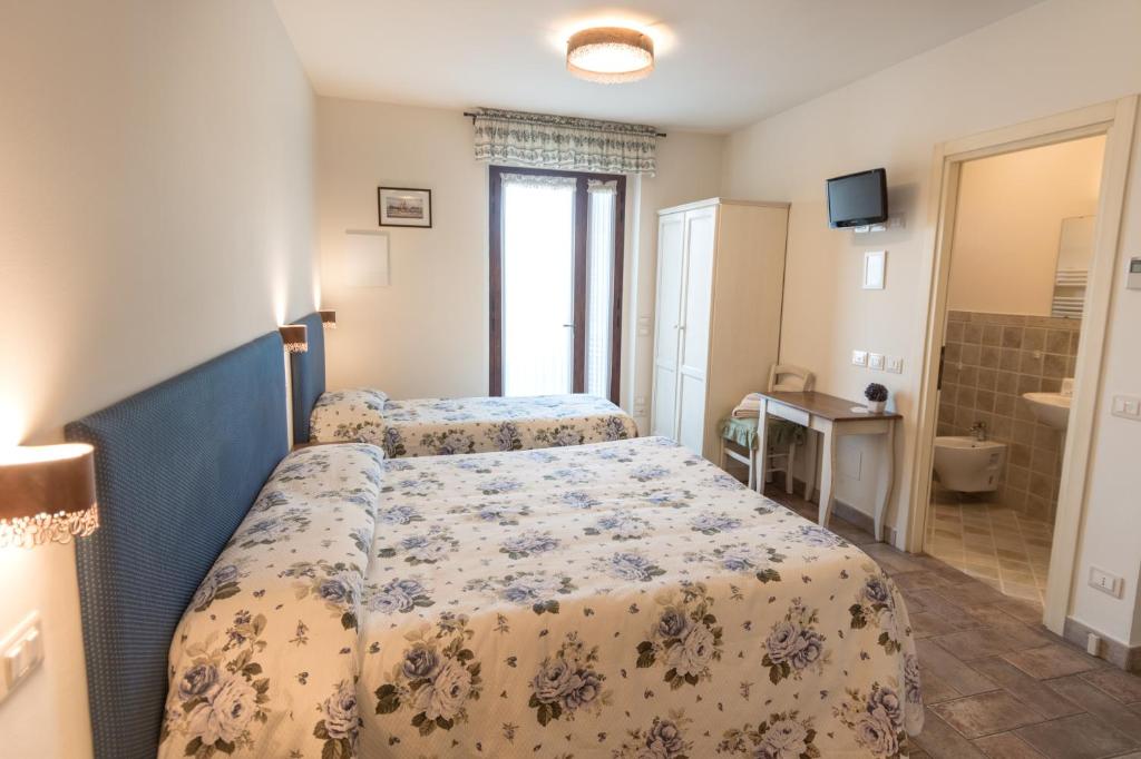 Postel nebo postele na pokoji v ubytování Rosa di Assisi