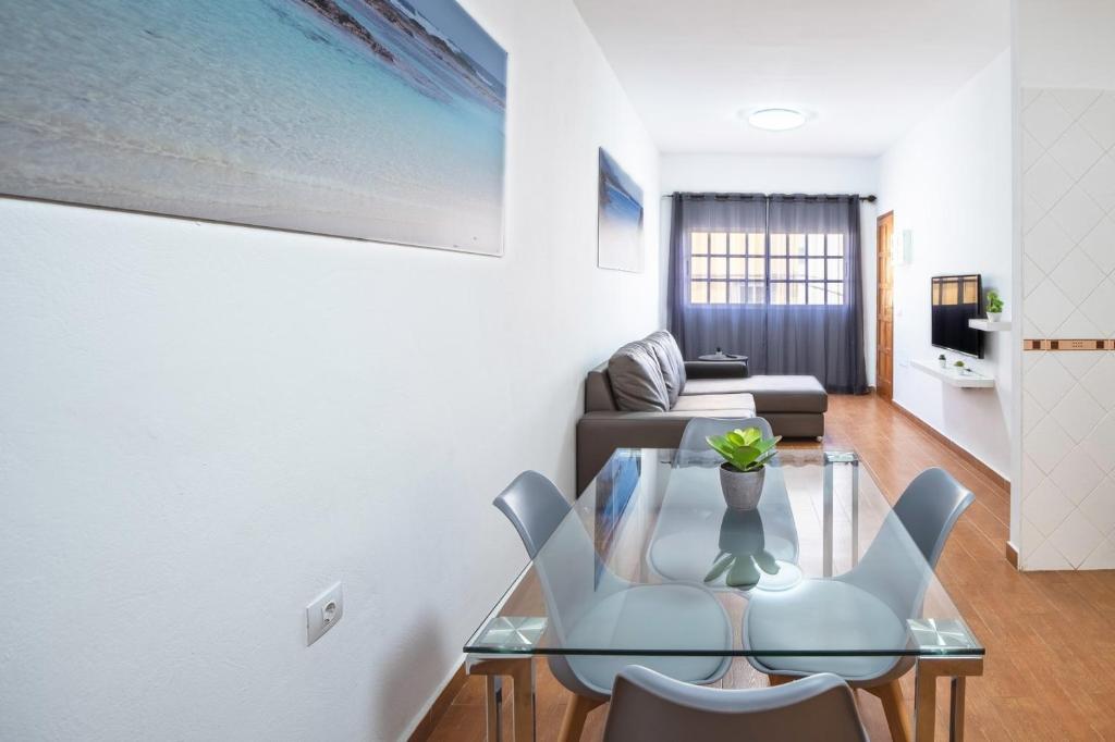 a living room with a glass table and chairs at Cotillo Sea 2 in Cotillo