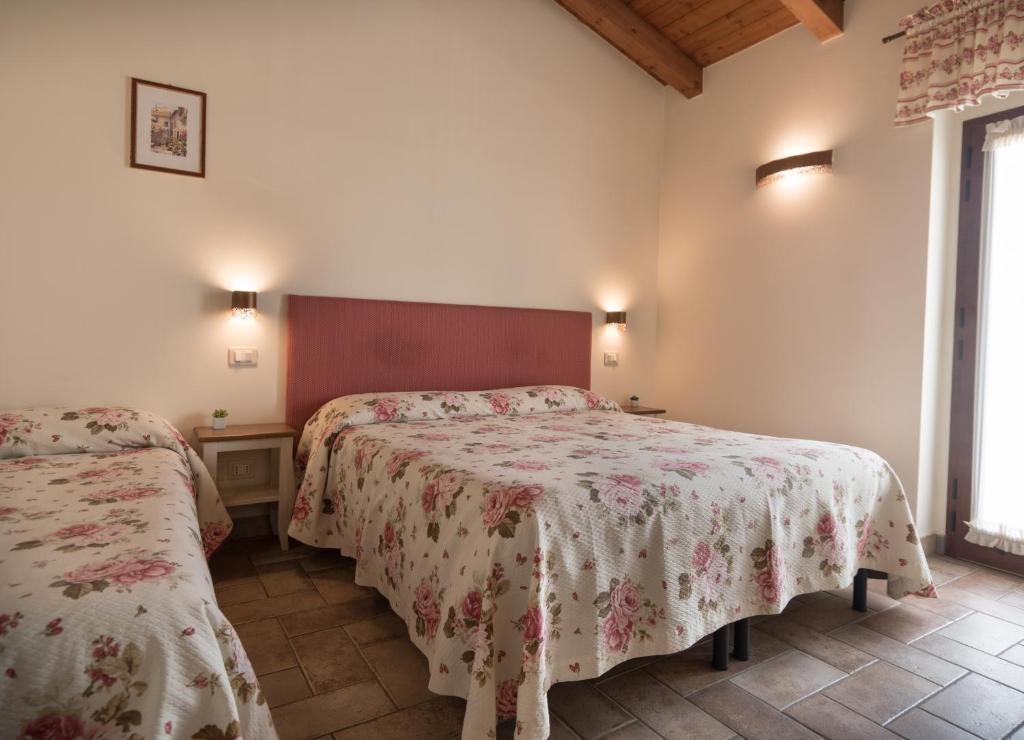 Postel nebo postele na pokoji v ubytování Rosa di Assisi