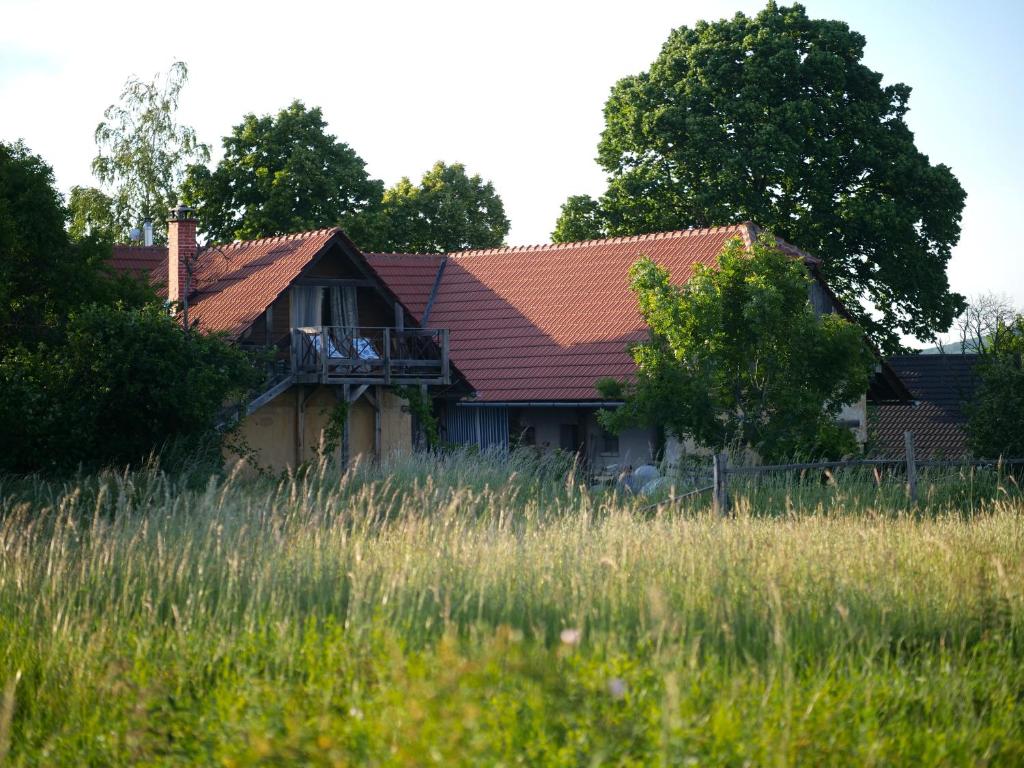 an old house with a red roof in a field at Selanka Off road Hill View in Moravské Lieskové