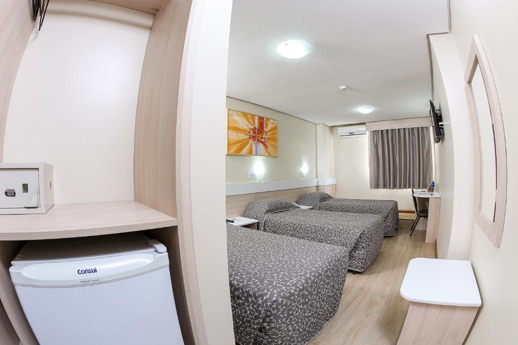 Un pat sau paturi într-o cameră la Hotel Express Aeroporto