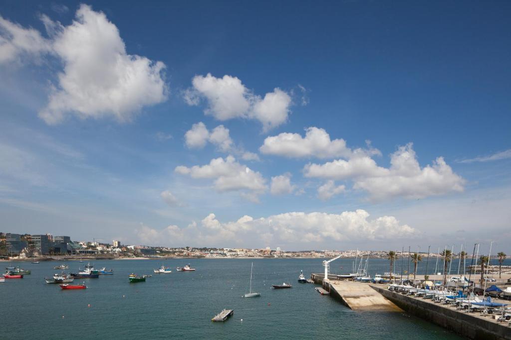 a group of boats in the water near a harbor at Villa Cascais Boutique Hotel in Cascais