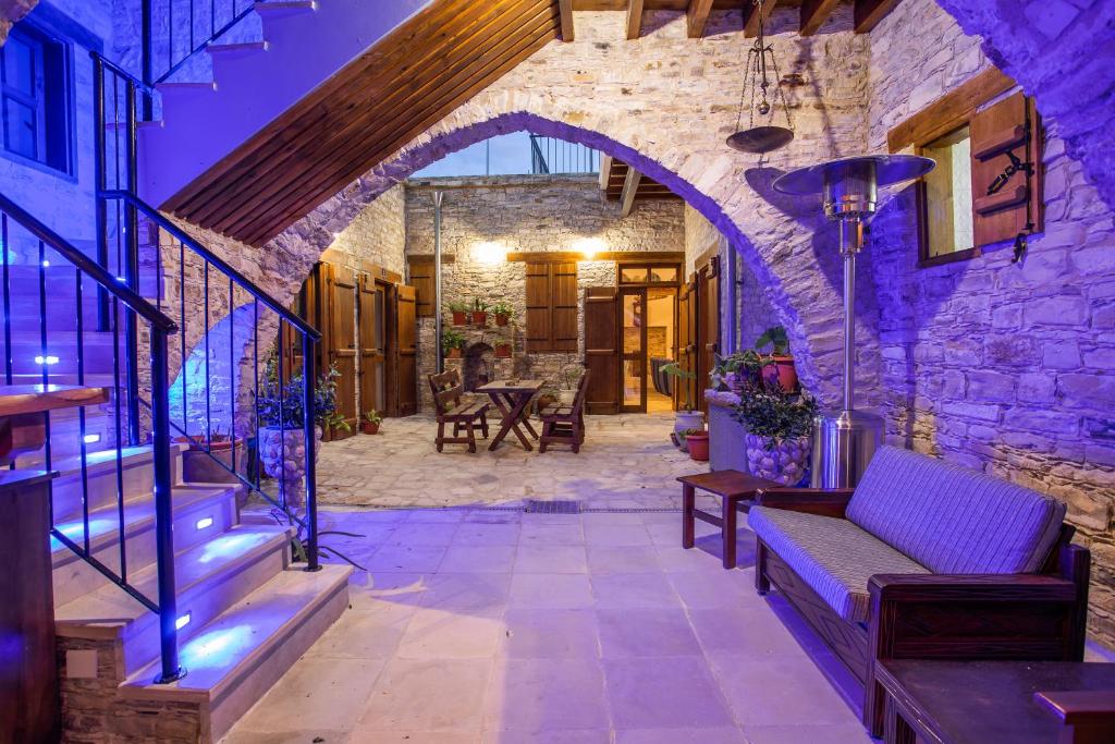 a stone house with a staircase and a stone wall at Lazaros Stonehouse in Pano Lefkara