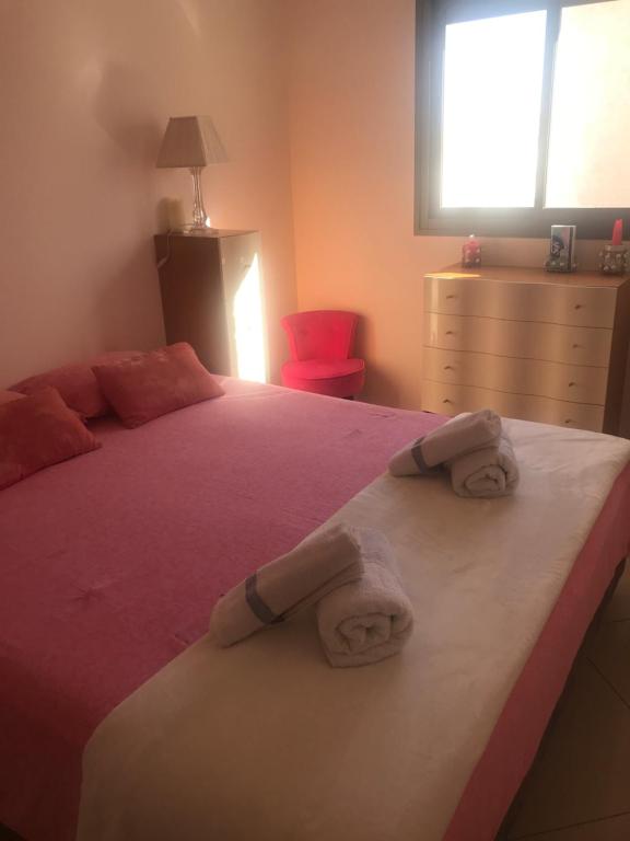 a bedroom with a bed with towels on it at CHAMBRES D’HÔTES EILAT in Eilat