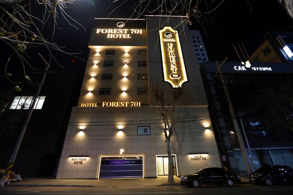 a building with a sign for a hotel room at Forest 701 Hotel in Daegu