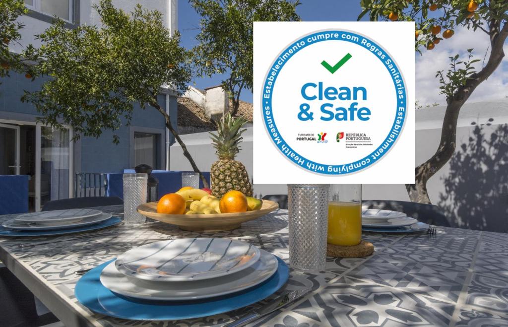 a table with a clean and safe sign on it at OrangeTreeHouses in Montijo