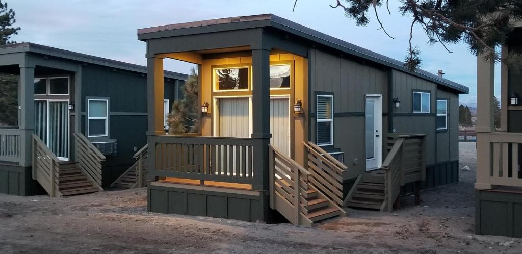 a tiny house with a front porch and a door at Sierra Meadows Ranch in Mammoth Lakes