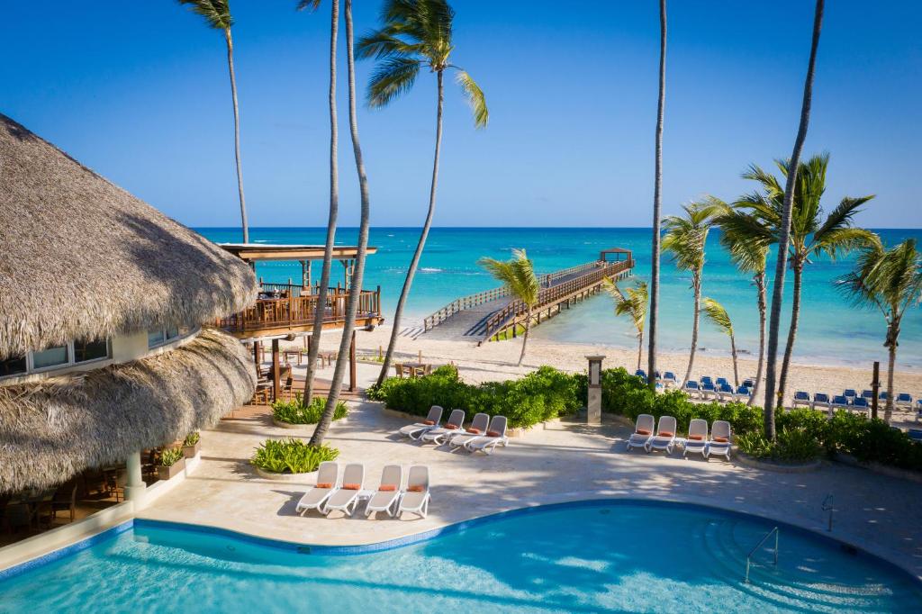 a beach with palm trees and palm trees at Impressive Punta Cana in Punta Cana