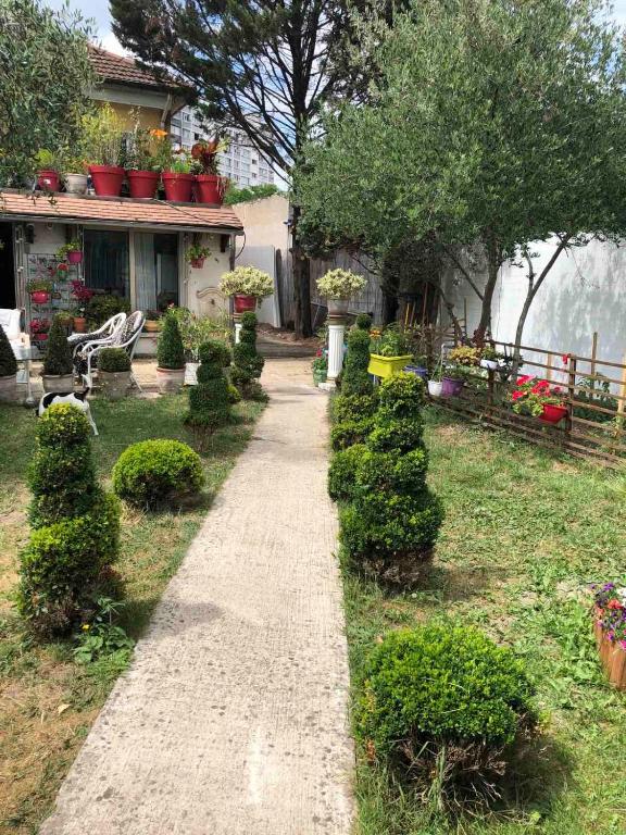een tuin met een pad naar een huis bij Villa Baroque in Pierrefitte-sur-Seine