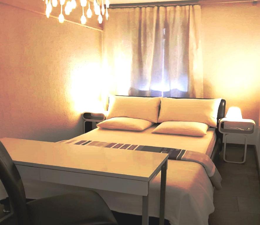 een slaapkamer met een bed met een tafel en een raam bij EXCELSIOR Apartments Rovinj in Rovinj