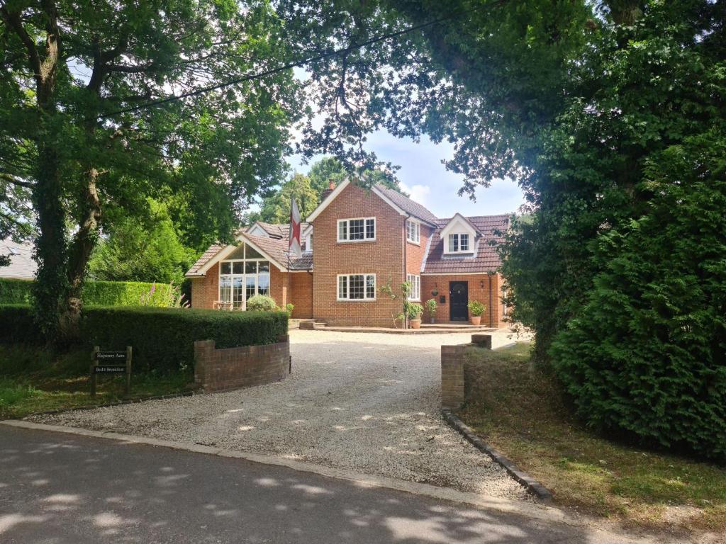 a house with a driveway in front of it at Ha'penny Acre in Sherfield English