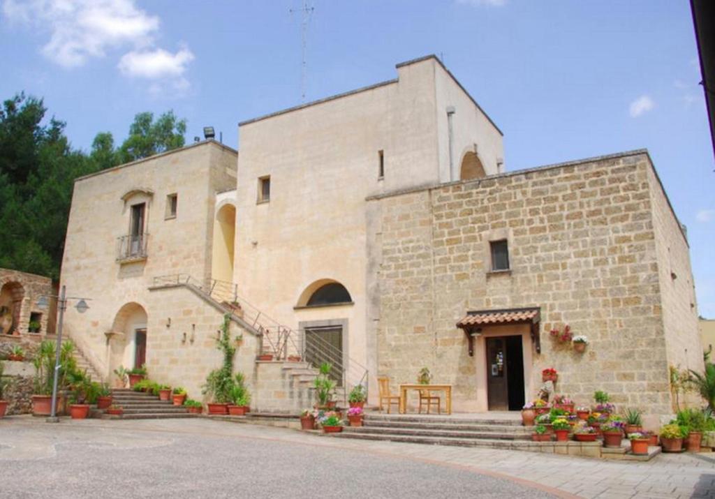 a large stone building with stairs in front of it at Casale Sombrino in Supersano