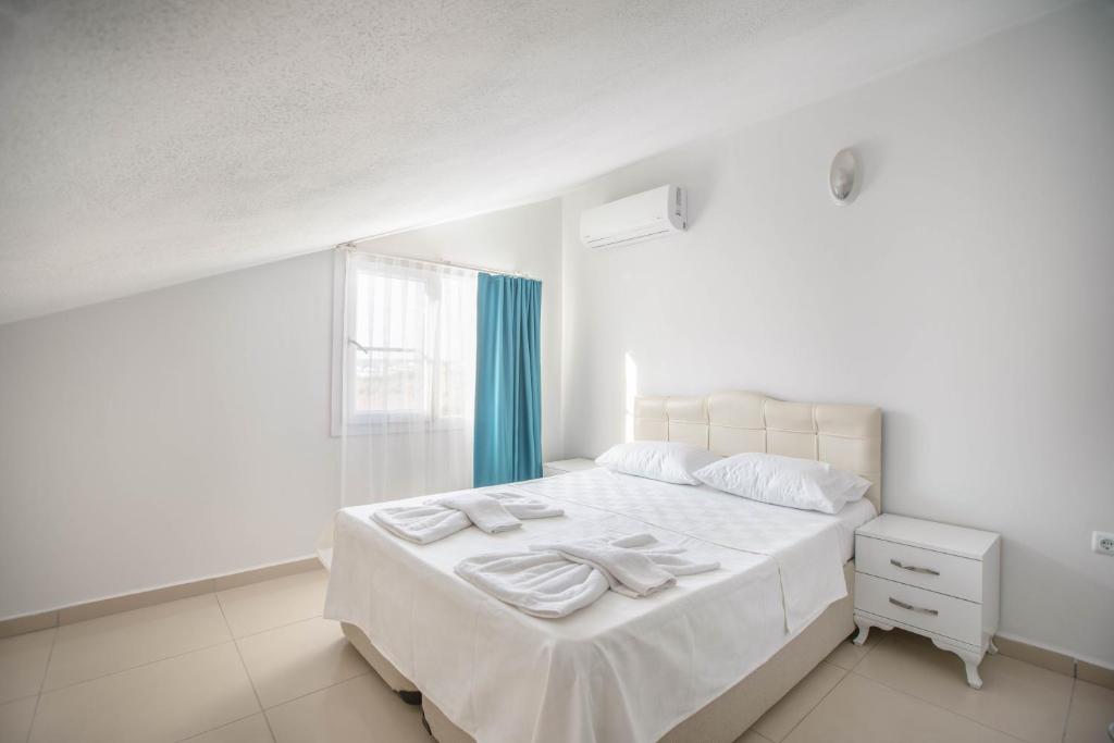 Postel nebo postele na pokoji v ubytování Antiocha Residence