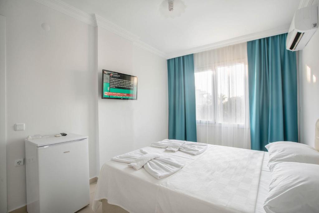 Postel nebo postele na pokoji v ubytování Antiocha Residence