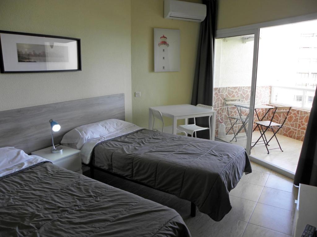 A bed or beds in a room at JSM Apartamentos