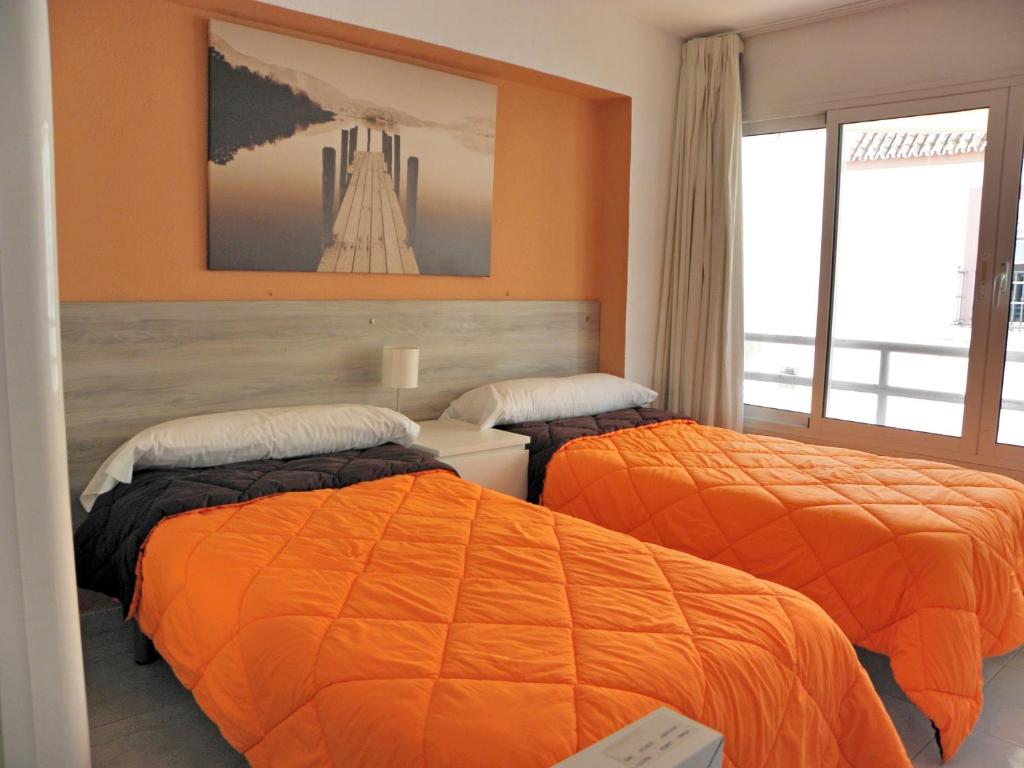 A bed or beds in a room at JSM Apartamentos