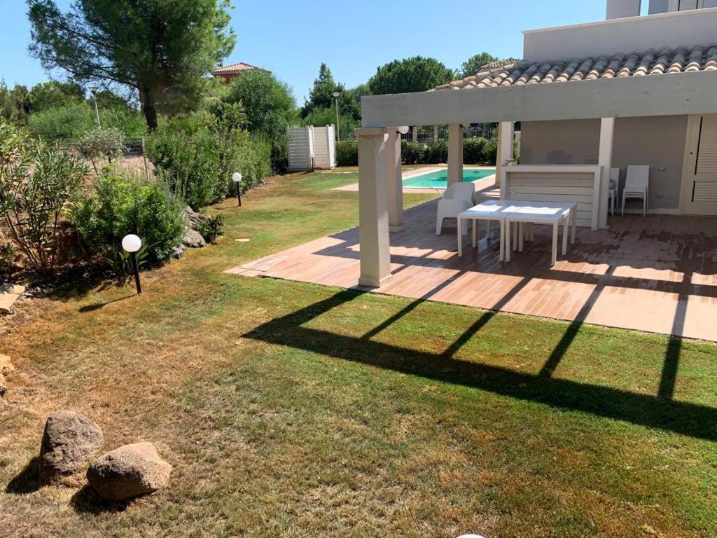 a backyard with a picnic table and a pool at VILLA ERSILIA in Porto Columbu - Perdʼe Sali