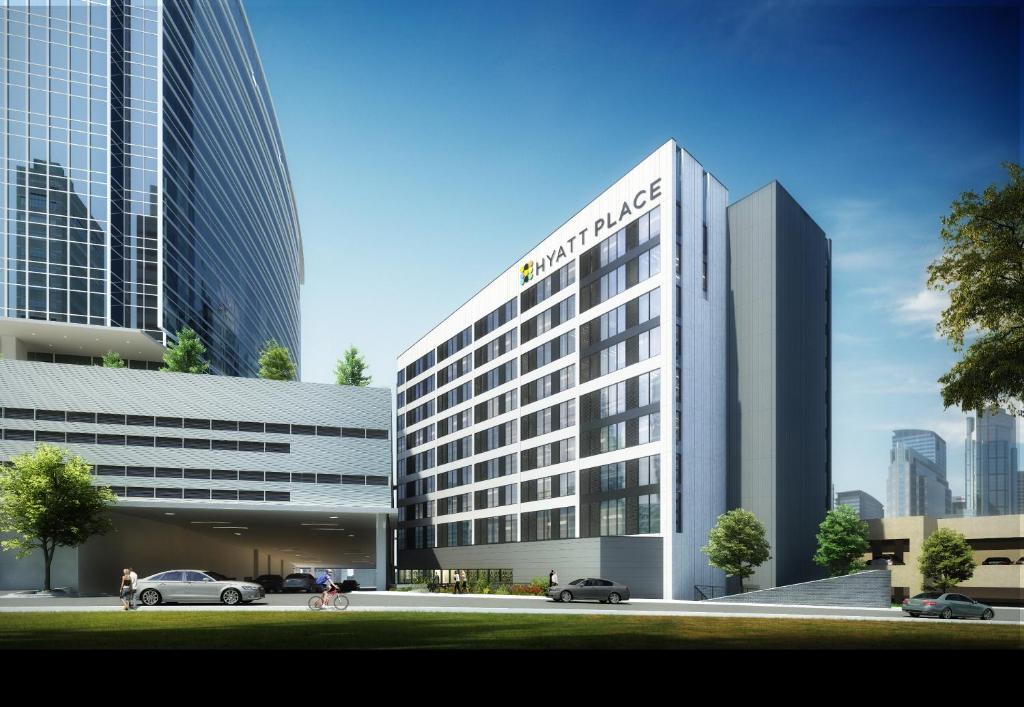 una representación de un edificio de oficinas con coches aparcados delante en Hyatt Place Atlanta/Perimeter Center, en Atlanta