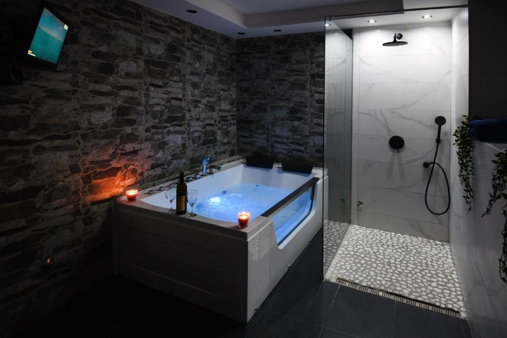 a bath tub in a bathroom with a fireplace at TASOS in Belgrade