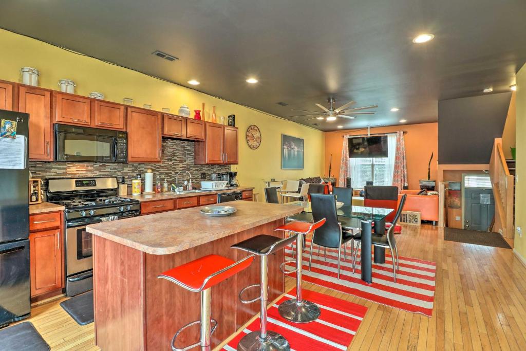 a kitchen with wooden cabinets and a red and white rug at Modern Urban Escape 2 Mi to Downtown Detroit! in Detroit