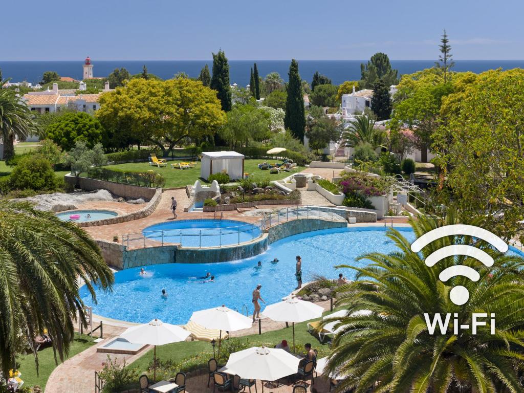 a view of a pool with people in a resort at Rocha Brava Village Resort in Carvoeiro