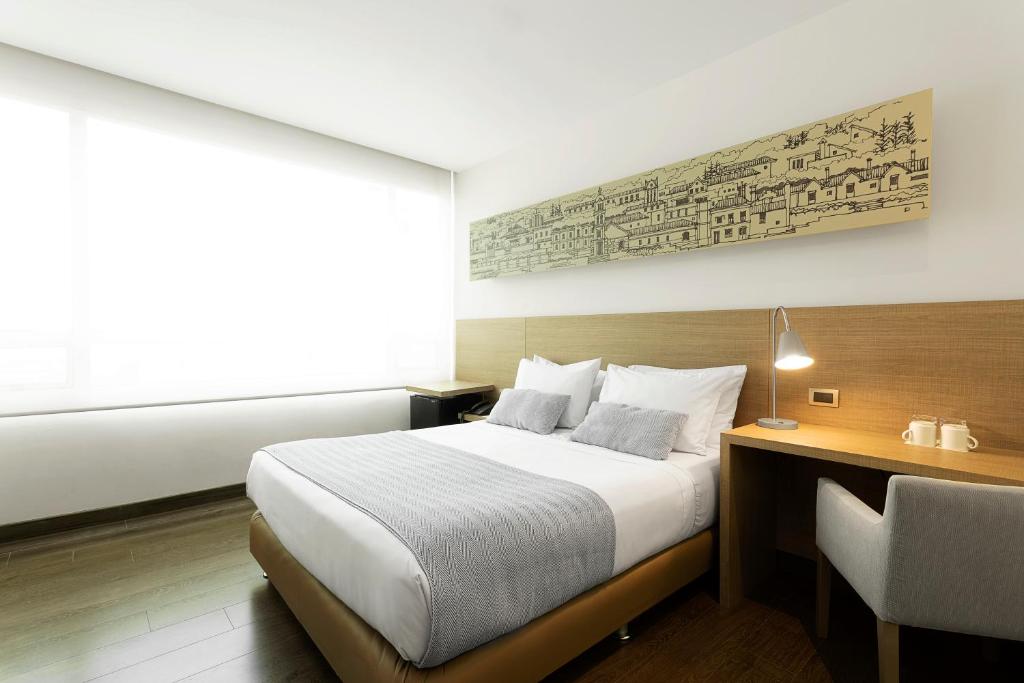 Postel nebo postele na pokoji v ubytování Hotel bh Usaquén