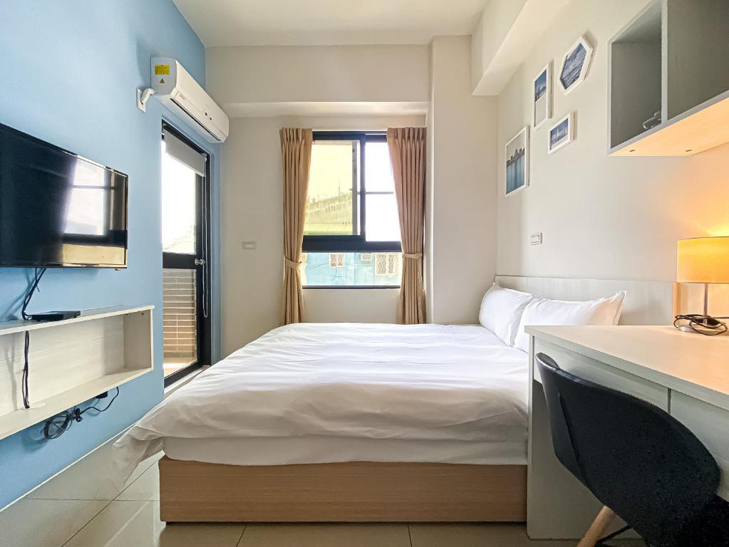 Uma cama ou camas num quarto em Adagio Hostel