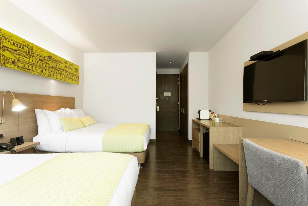 Postel nebo postele na pokoji v ubytování Hotel bh Usaquén