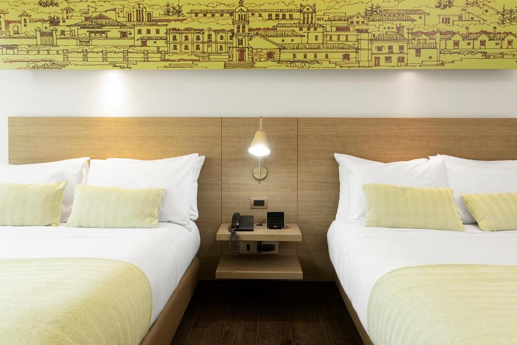 Postel nebo postele na pokoji v ubytování Hotel bh Usaquén