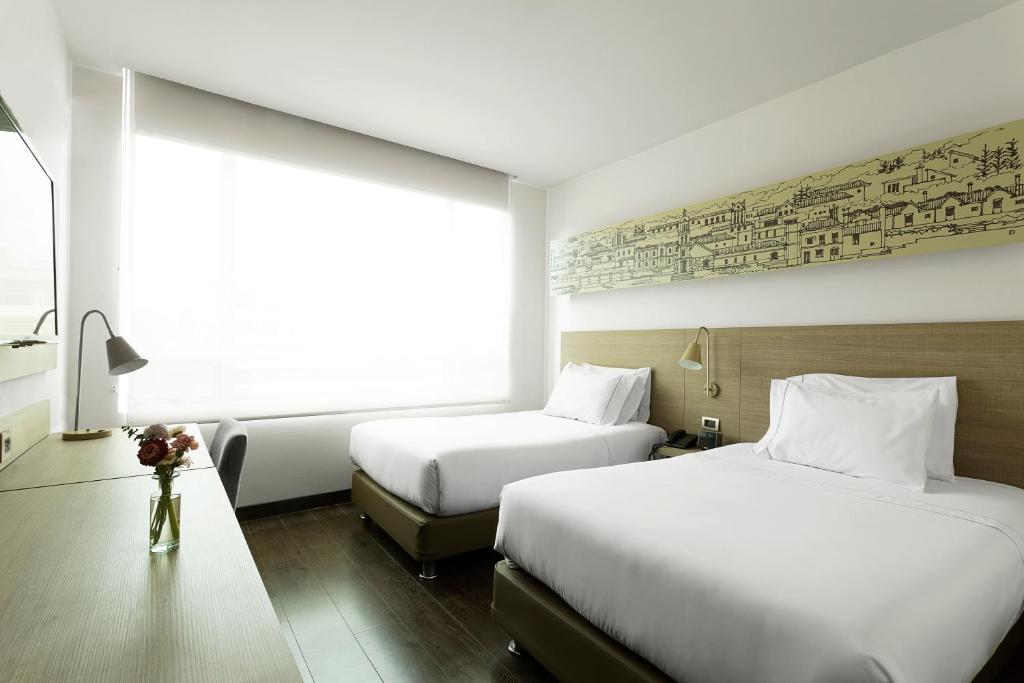 Postel nebo postele na pokoji v ubytování Hotel bh Usaquén